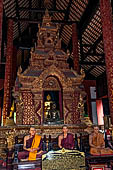 Chiang Mai - The Wat Phra Singh temple. The ubosot (ordination hall). Detail of the ku, a large ornate Buddha throne that sits in the middle of the building. 